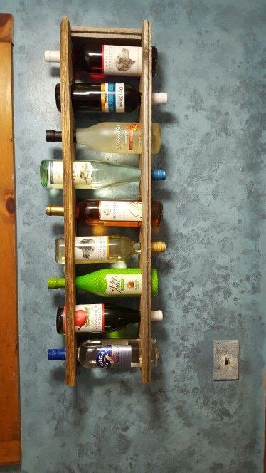 A Wall Mounted Wine Rack Holding Several Bottles