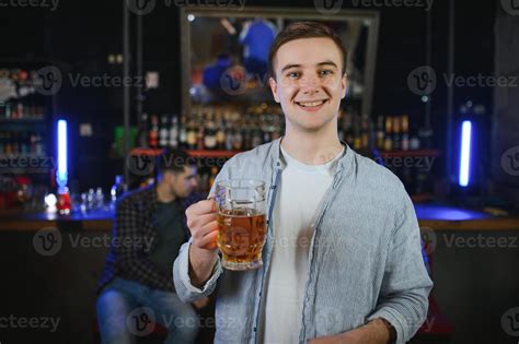 Handsome Bearded Man Drinking Beer At The Bar Counter In Pub 48225538