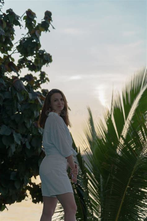 Portrait Of Brunette Girl Standing At Dawn Against A Palm Tree Stock Photo Image Of Adventure