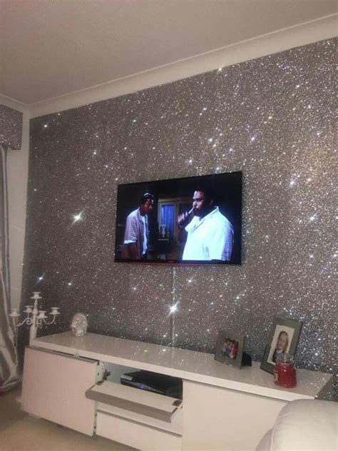 Two Men Are On The Television Screen In This Room With Silver Glitter