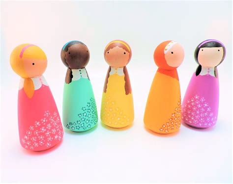 Five Colorful Wooden Dolls Lined Up In A Row