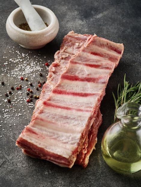 Premium Photo Raw Pork Ribs With Spices Salt Pepper And Rosemary