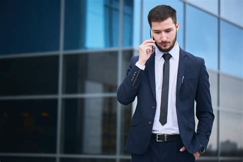 Retrato De Un Joven Empresario En Un Traje Azul Hablando Por Un