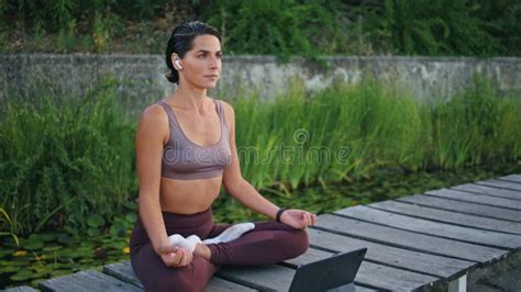 Tranquil Yogini Meditating Tablet On Park Bench Woman Lotus Pose