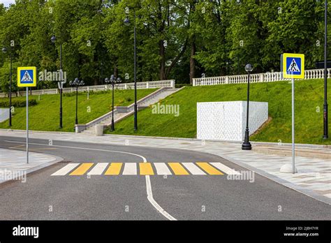 Pedestrian Crossing Across The Road With Zebra Crossing And Signs Stock