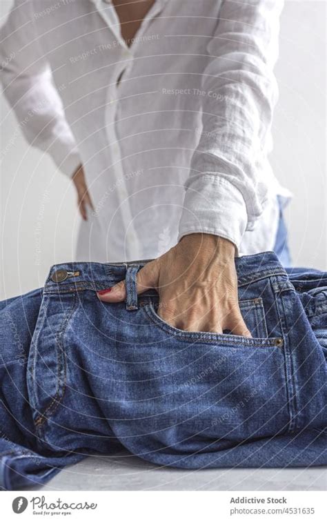 Woman Putting Hand In Pocket Of Jeans A Royalty Free Stock Photo From