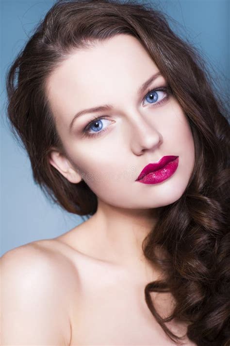 Brunette Woman With Creative Make Up Violet Eye Shadows Full Red Lips Blue Eyes And Curly Hair