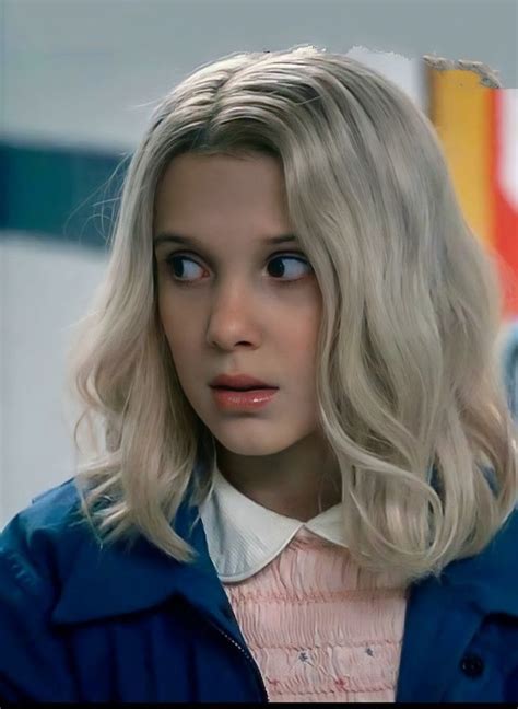 A Woman With Blonde Hair Wearing A Blue Jacket