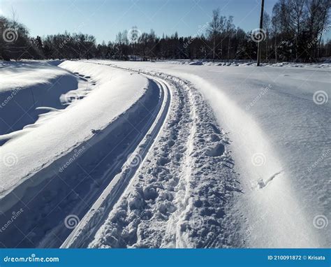 A Cross Country Ski Track Forms Curved Trail That Disappears Into The