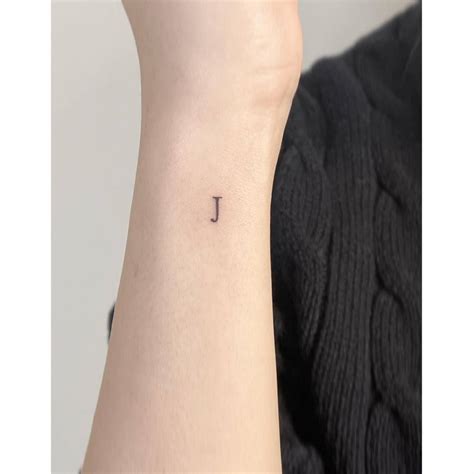 Minimalistic Tattoo Of The Letter J Located On The