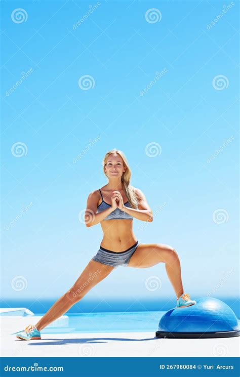 Lunge and Repeat. a Young Woman Working Out on a Sunny Patio with a ... 