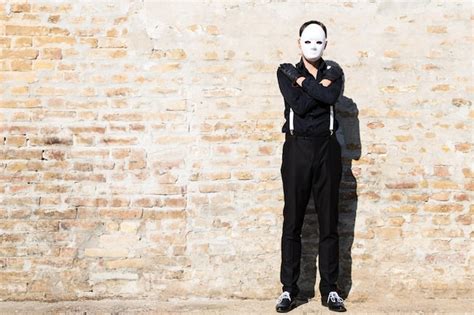 Premium Photo Man Wearing White Mask While Standing With Arms Crossed