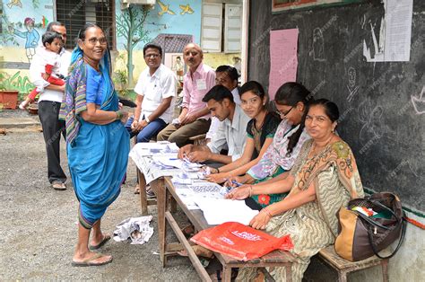 Premium Photo People And Polling Officers Looks For A Voters Name In