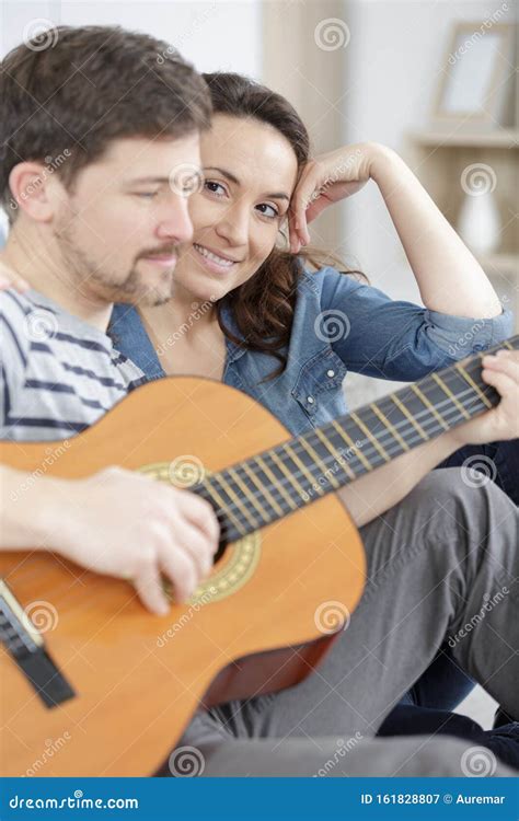 Man Playing Guitar For Pregnant Wife Stock Image Image Of Bedroom