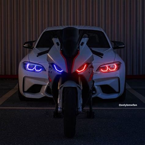 Two White Sports Cars Parked Next To Each Other In A Parking Lot With