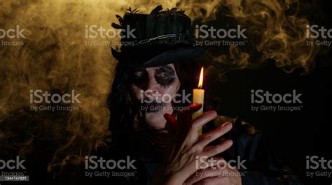 Sinister Old Mature Woman In Carnival Costume Of Halloween Witch Making