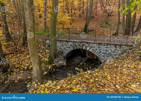 Autumn View Of A Stone Arch Bridge Over Kunraticky Potok Stream In