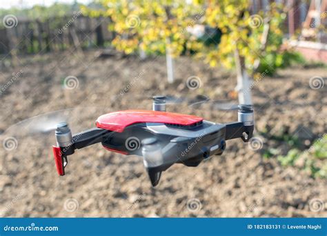 Small Sized Red Drone with High Resolution Camera Hovering in Air for ...