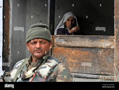 An Elderly Kashmiri Woman Waits For Customers Inside Her Milk Shop As