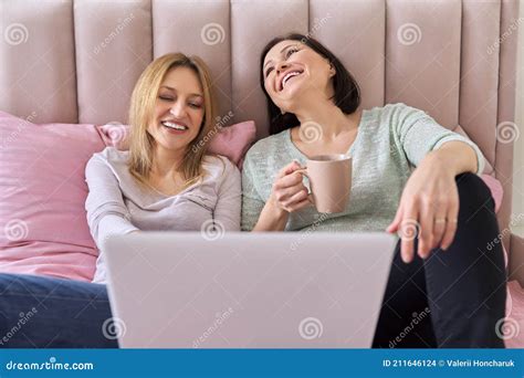 Two Mature Women Attending Art Class In Community Centre With Teacher Royalty Free Stock Image