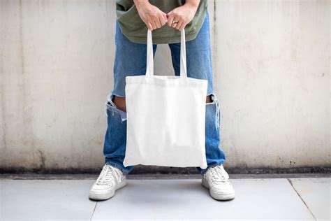 Casual Outdoor Man Holding Canvas Bag Mockup from Front View Free ...