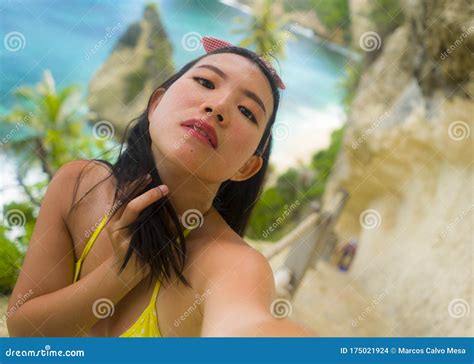 Young Beautiful And Happy Asian Japanese Woman In Bikini Taking Selfie