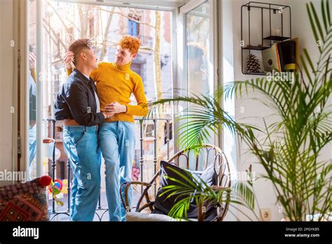 Beautiful Gay Couple Being Romantic By The Window Holding Each Other Lgbt Concept Stock Photo