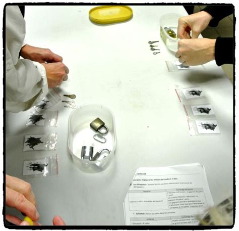 Several People Are Working On Some Type Of Object At A Table With