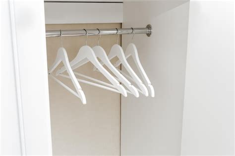 Premium Photo | White empty wardrobe closet with hangers wooden white ...