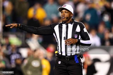 Referee Shawn Smith signals for a penalty during an NFL football game ...