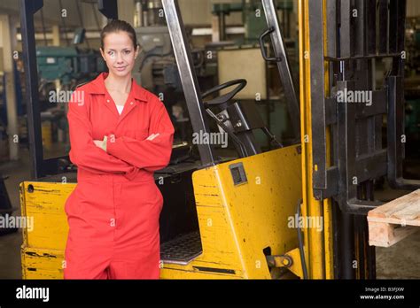 Warehouse Worker Standing By Forklift Stock Photo Alamy