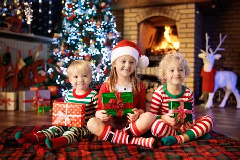 Child At Christmas Tree Kids At Fireplace On Xmas Stock Image Image