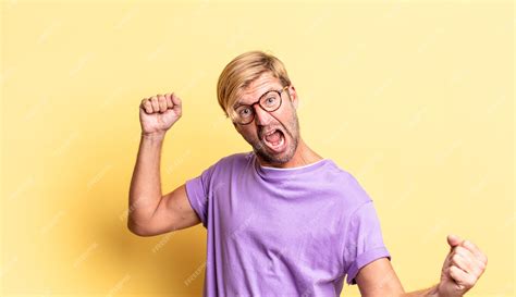 Premium Photo Handsome Blond Adult Man Shouting Triumphantly Looking