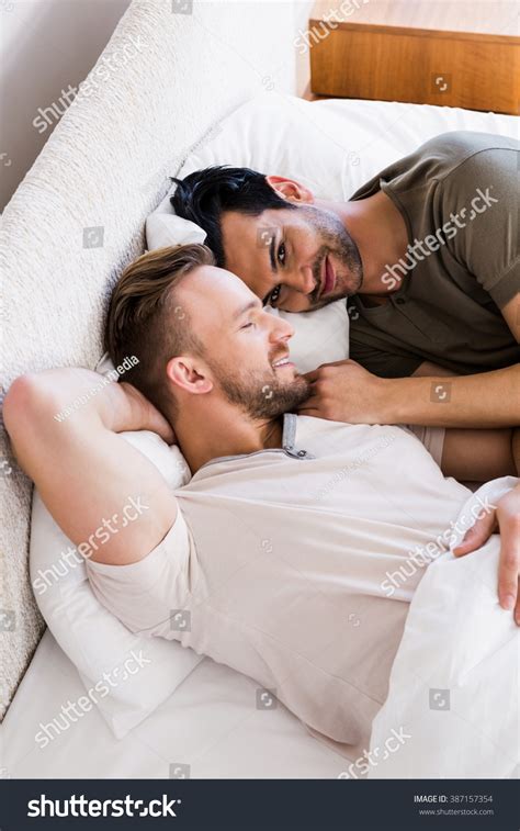 Happy Gay Couple Lying On Bed Stock Photo Edit Now