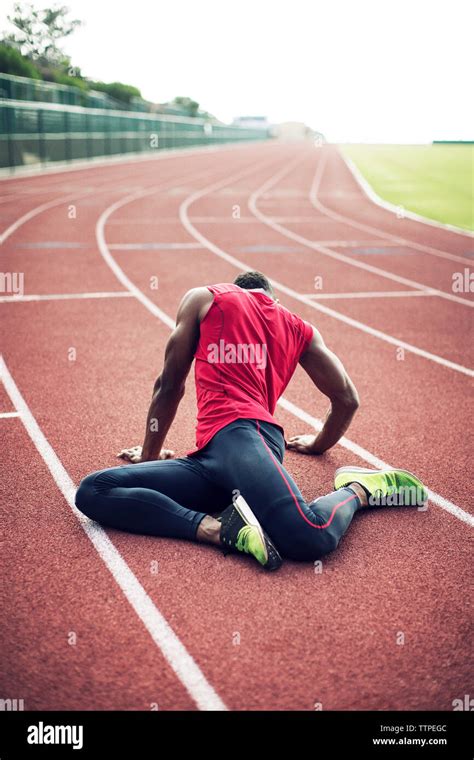 Male Athlete Stretching On Running Tracks Stock Photo Alamy