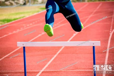 Athlete Jumping Above The Hurdle Stock Photo Picture And Low Budget