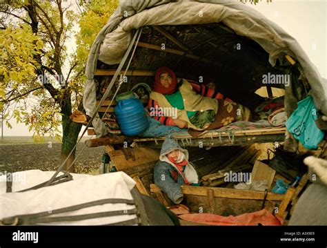 Family in a traditional gypsy caravan interior, Romania Stock Photo ...