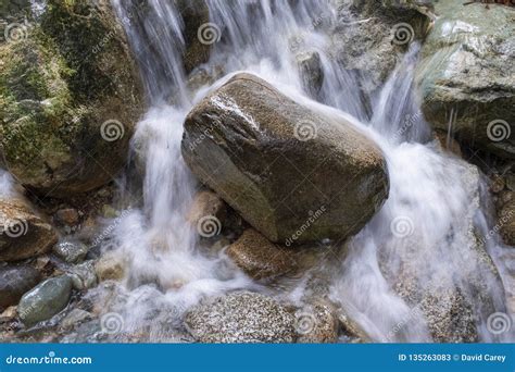 Water Rushing Over A Large Rock In A Stream Stock Image Image Of