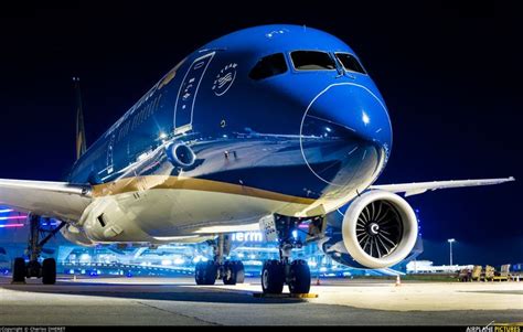 an airplane is parked on the tarmac at night