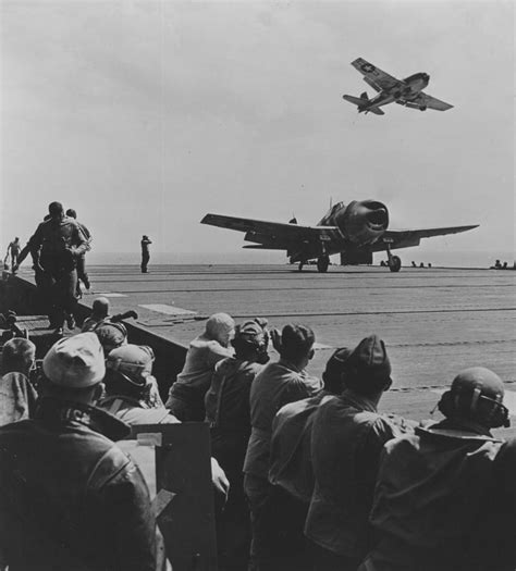 A US Navy Hellcat Fighter Aircraft Landing On The Deck Of A Carrier ...