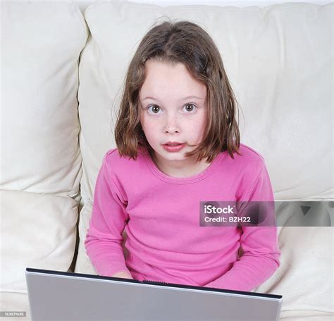 Girl Sitting On The Sofa And Using Laptop Stock Photo Download Image