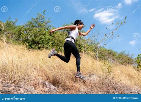 Young Black Woman Running And Jumping At Forest Trail Stock Image