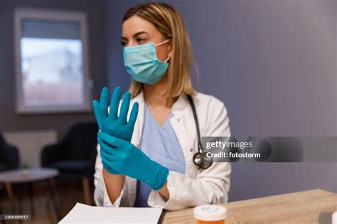 Selective Focus Shot Of Female Doctor Putting On Protective Gloves High