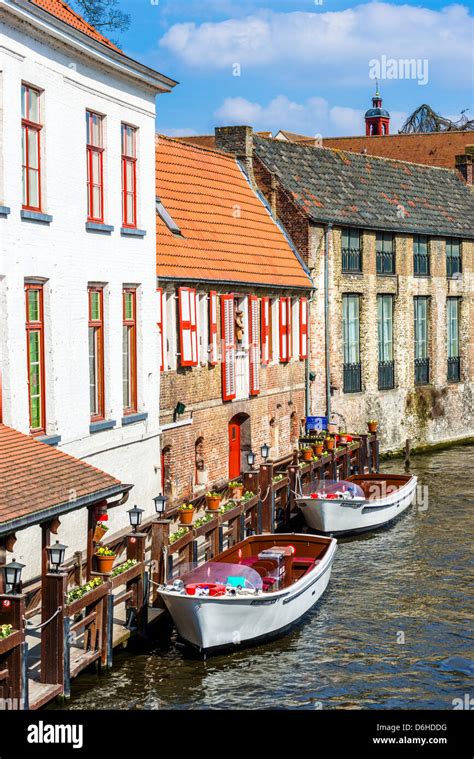 Canal and tourist boat in Bruges, Belgium Stock Photo - Alamy