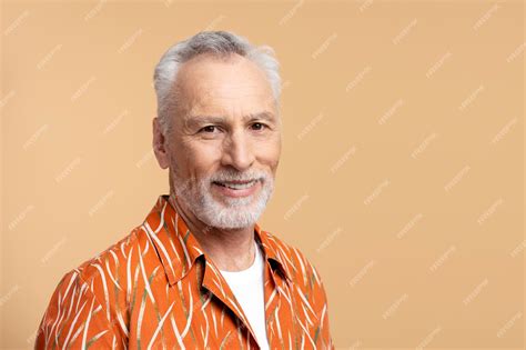 Premium Photo Smiling Retired Gray Haired Man In Orange Shirt Looking