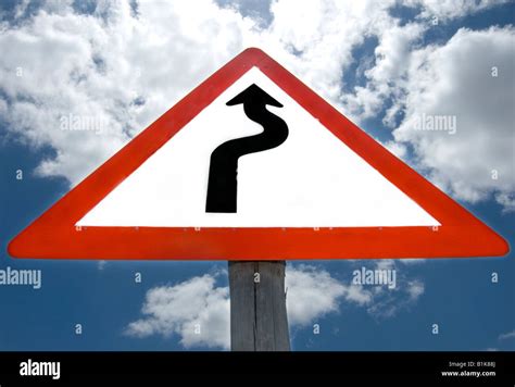 Roadside sign warning of dangerous road ahead Stock Photo - Alamy