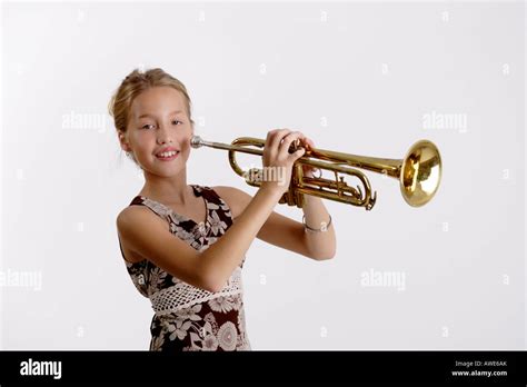 Stock Photograph of a young girl playing the trumpet Stock Photo ...