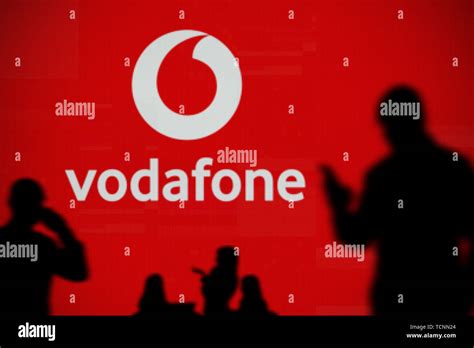 The Vodafone Logo Is Seen On An Led Screen In The Background While A