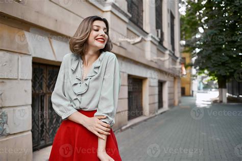 Pretty Woman In Red Skirt On The Street Walk Near The Building 22252719