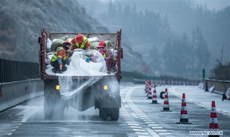 Workers Sprinkle Salt On Roads To Ensure Traffic Safety After Snow And